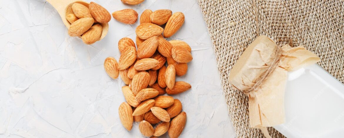 almond-milk-bottle-with-handful-grains-wooden-spoon-with-burlap-cloth-light-background-top-view_94046-8972 almond-milk-bottle-with-handful-grains-wooden-spoon-with-burlap-cloth-light-background-top-view_94046-8972